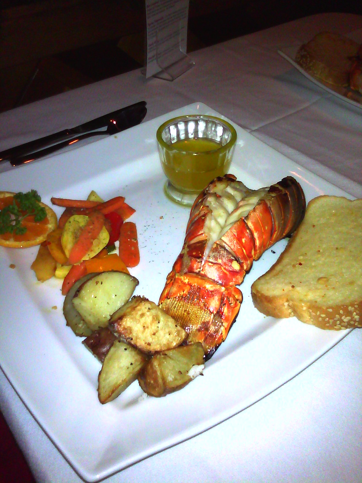 the lobster dish has many vegetables and side dishes