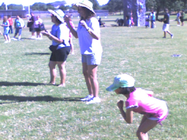 a group of children playing catch in the park