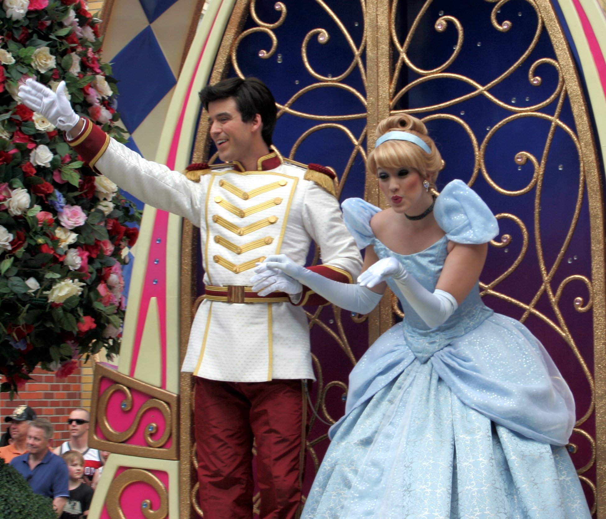 a couple dressed in disney princess costumes on stage