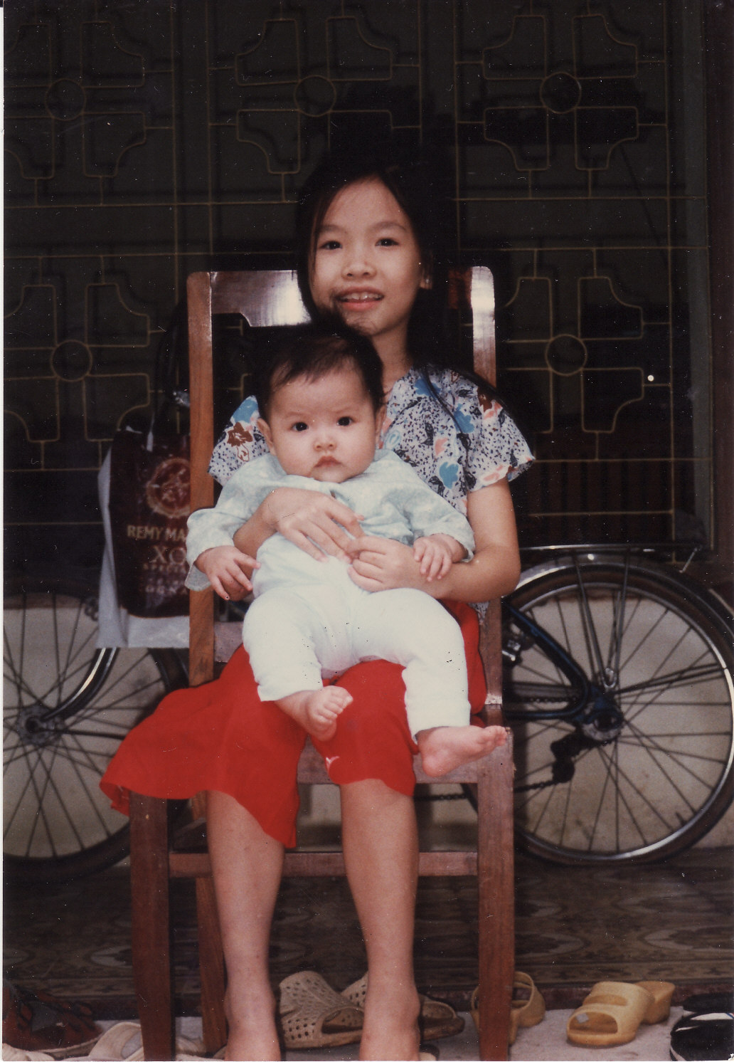 an asian woman with a baby in her lap