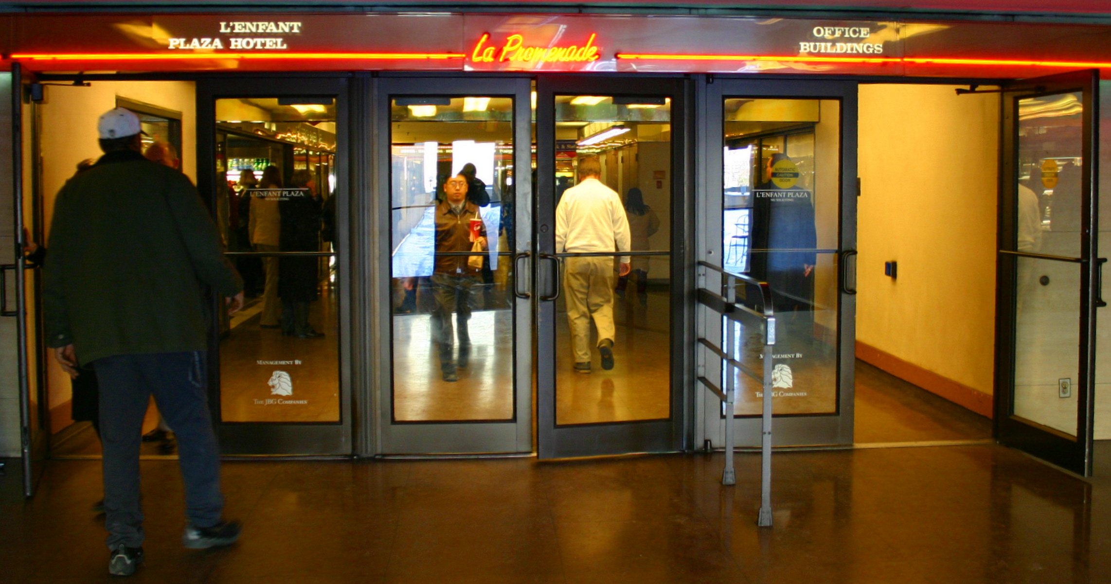 a man walks into a el with an entrance sign