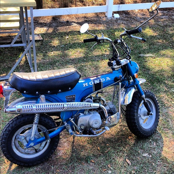 a blue dirt bike parked on the grass