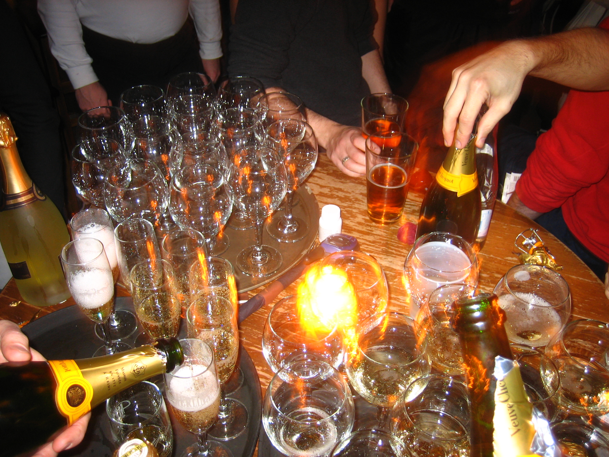 a table full of champagne glasses and bottles on it