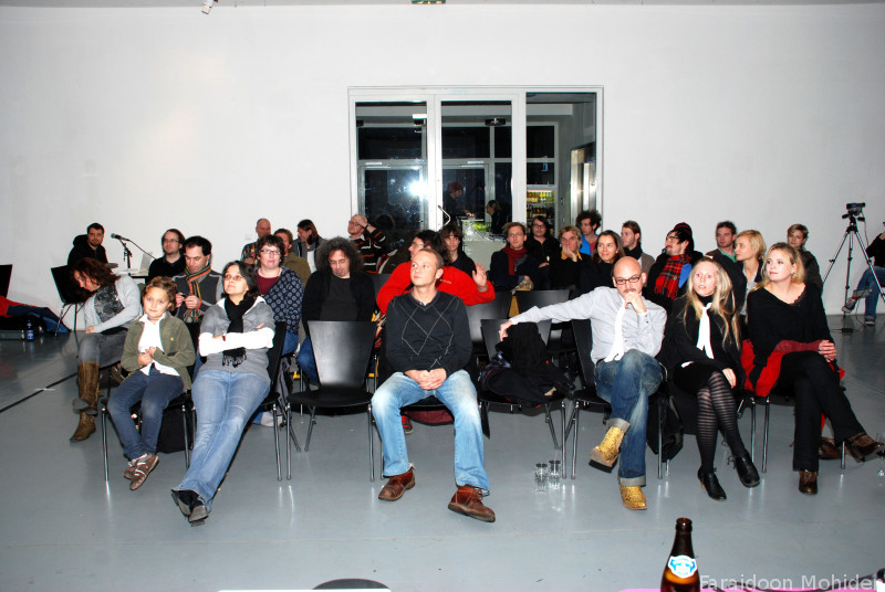 people sitting in chairs together in a room