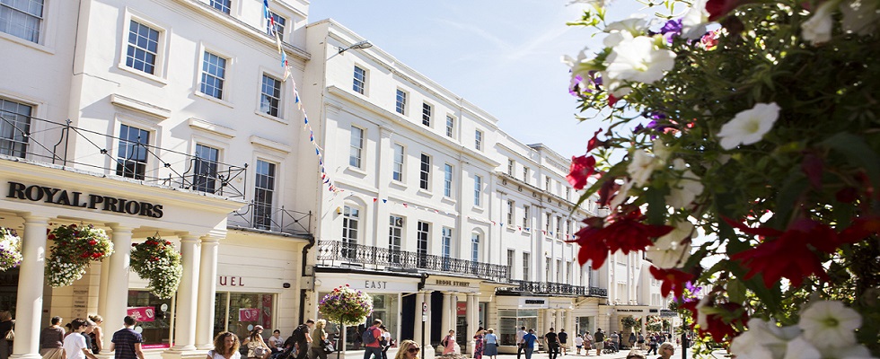 people standing on a street with the royal flowers