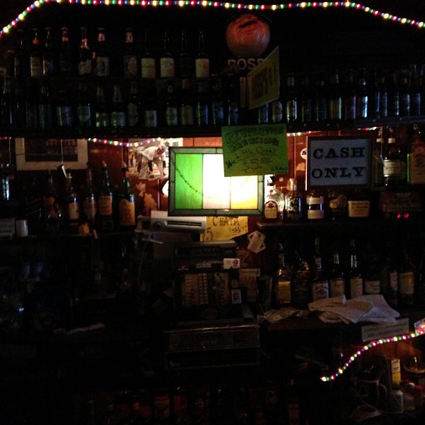 a bar filled with lots of bottles and lights