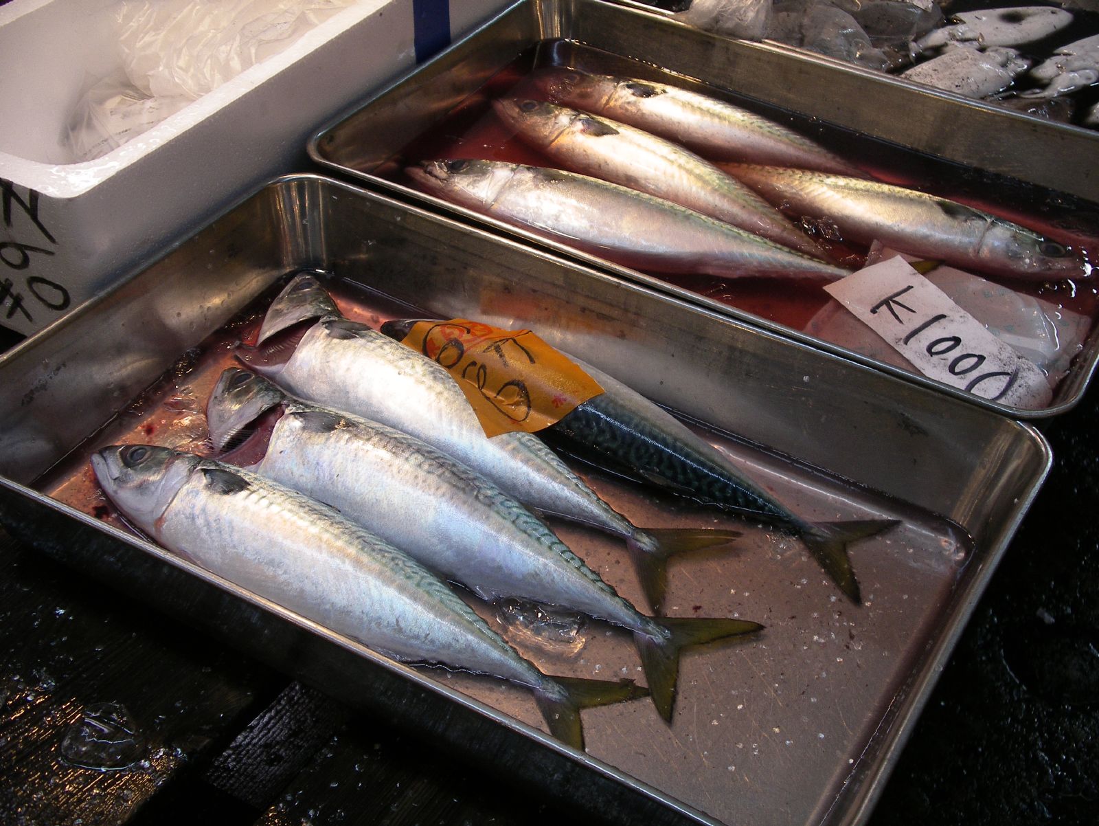 silver trays filled with fresh fish on a table