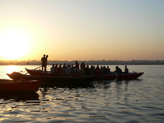 a large group of people in boats floating on top of water