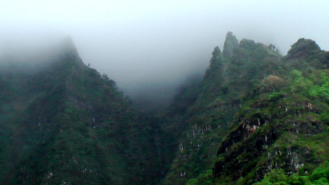 mountains shroud by fog on a cloudy day