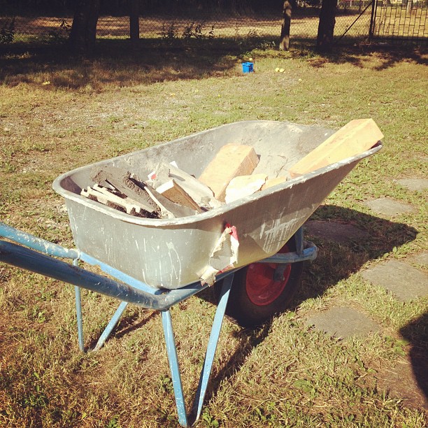 a wheelbarrow loaded with some items in a yard