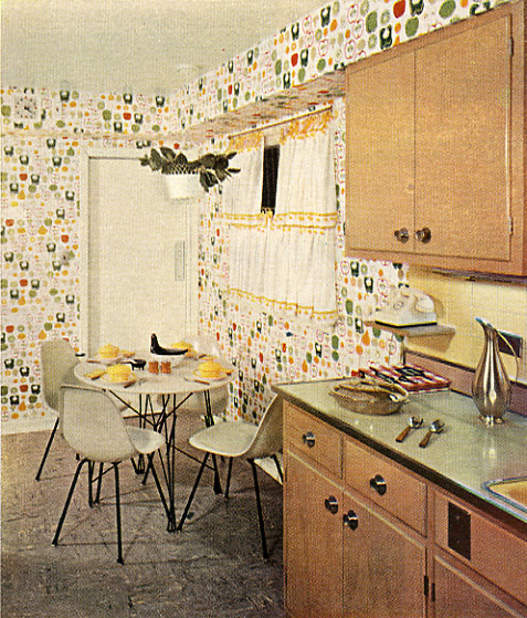 a dining room with a table a sink and many cupboards