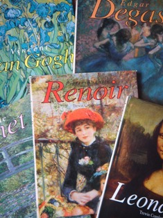 a close up of books with some paintings on them