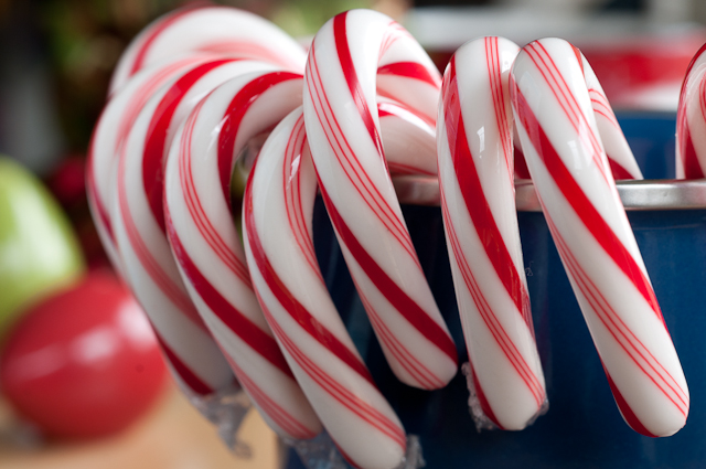 several candy canes that are arranged in a bucket