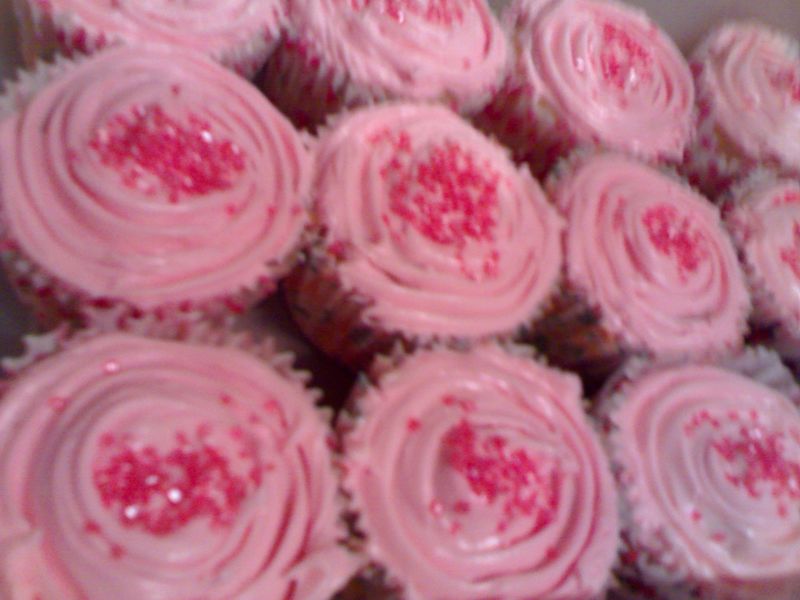 a close up of some cupcakes covered in frosting