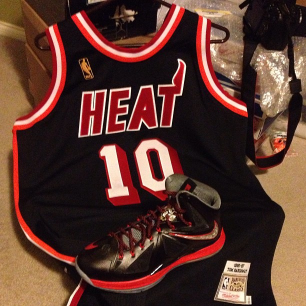 a pair of shoes sits in a jersey next to a bag