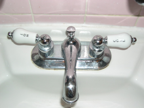 a faucet that is mounted to the side of a bathroom sink