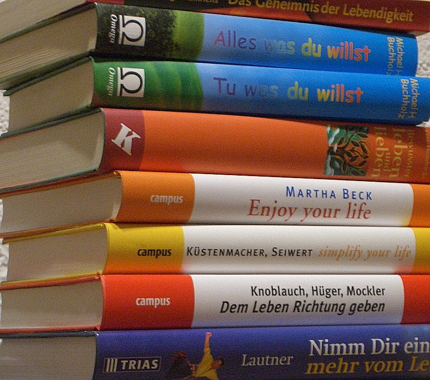 several books on a table stacked next to each other