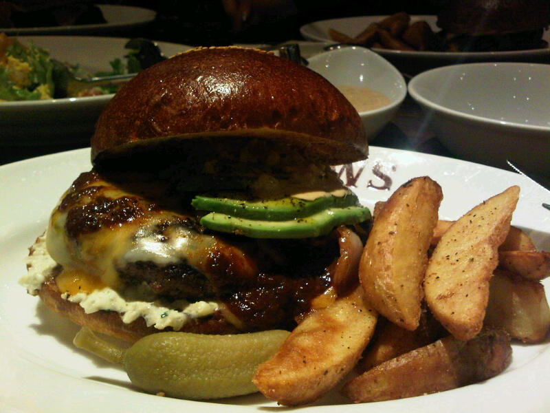 a meal of a hamburger, fries and vegetables