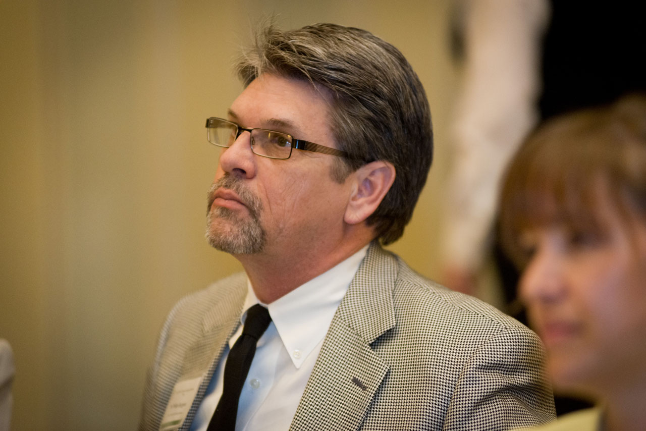 man in suit sitting looking away from the camera