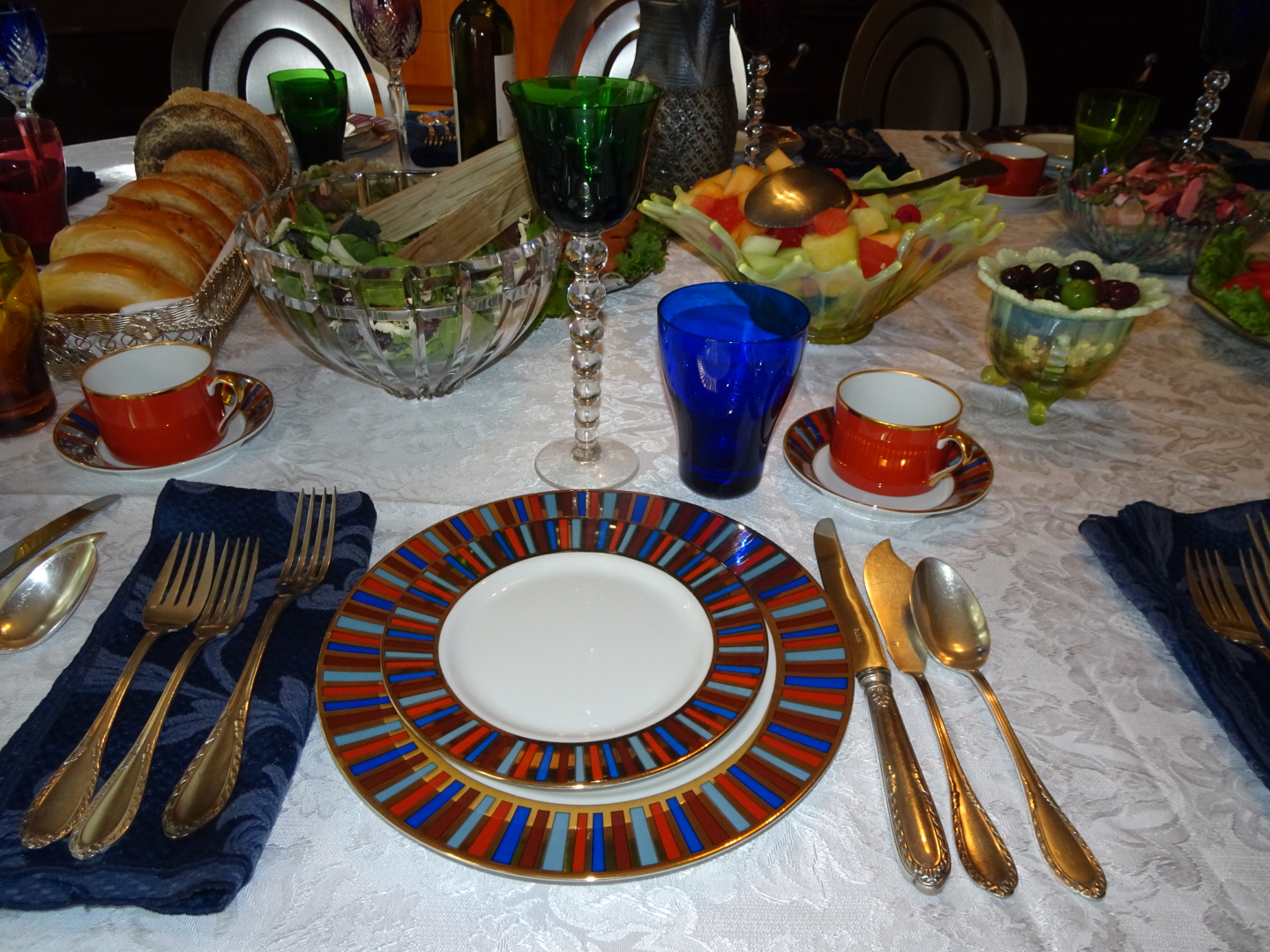 an elaborate dinner setting featuring blue and gold dishes