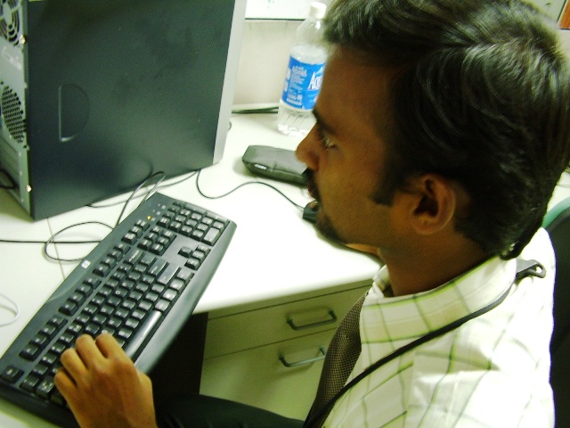 a man looking at an older computer screen