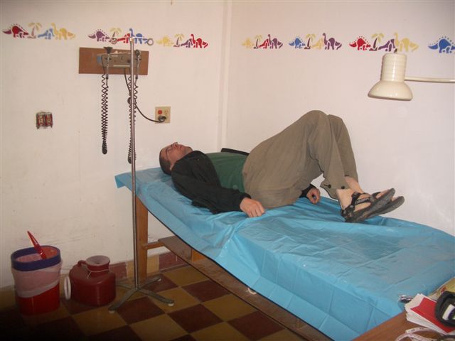 a man on a blue bed in a room