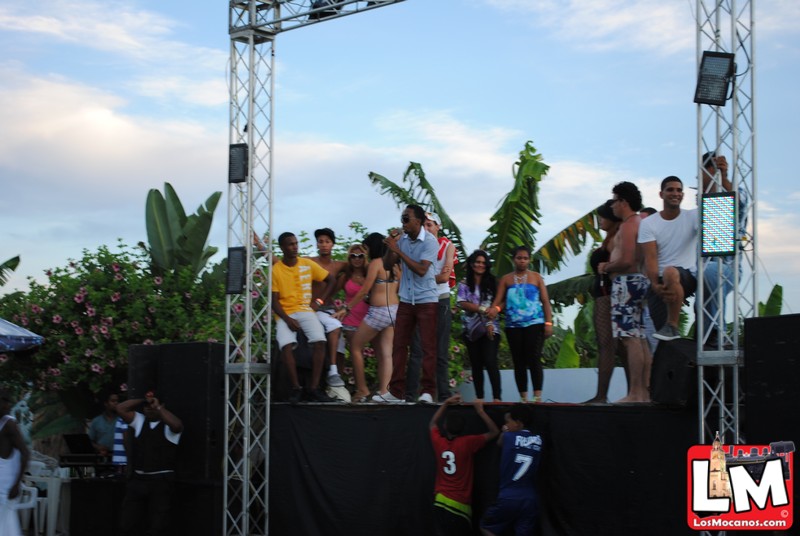 people are standing on top of the stage while an audience looks on