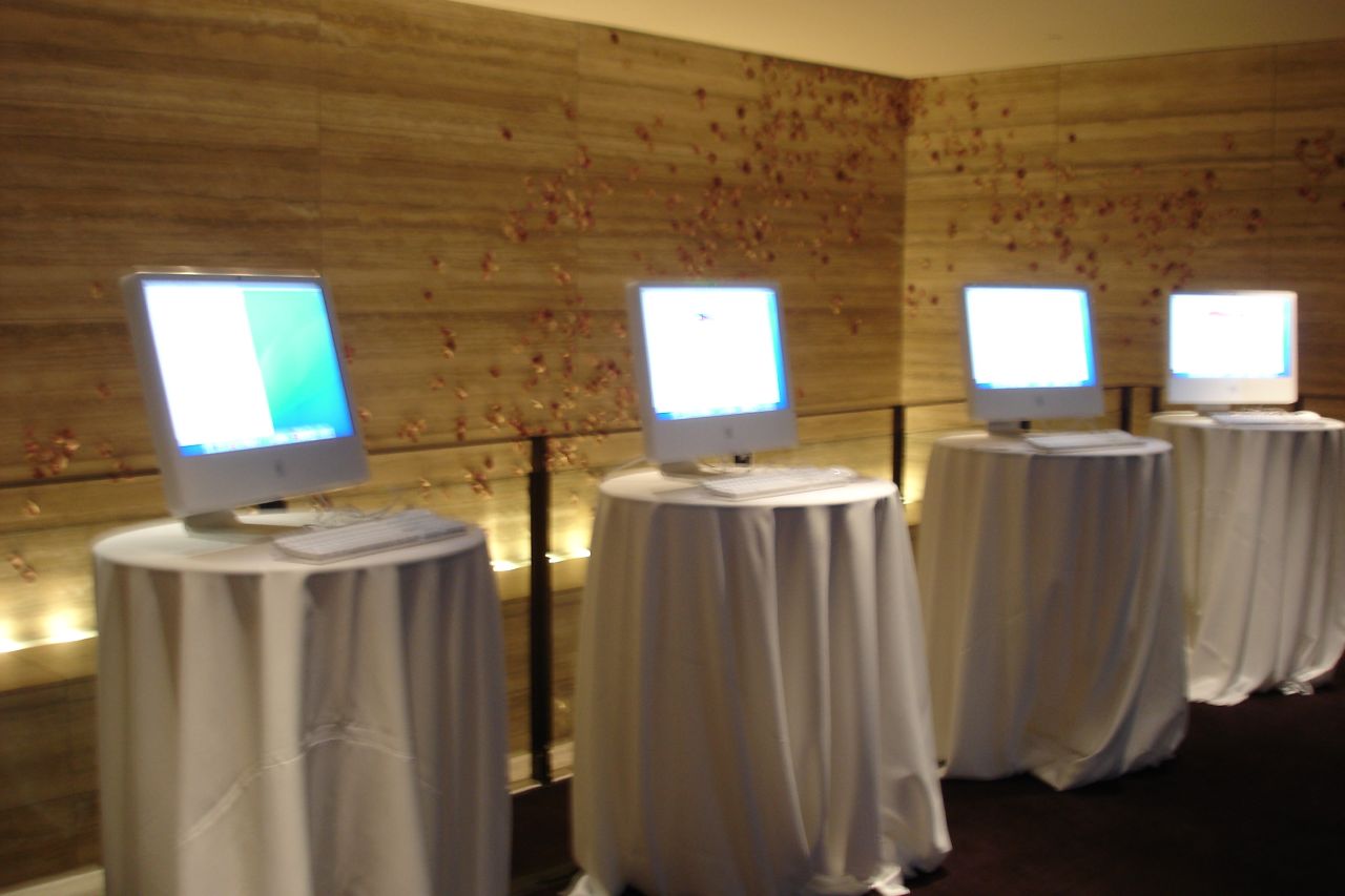 a row of monitors sitting on top of wooden walls