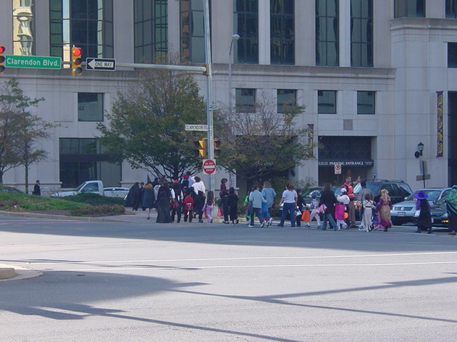 a group of people walking across the street