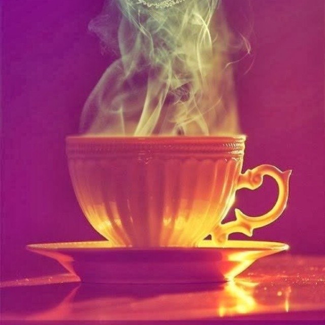 a tea cup with steam rising from it