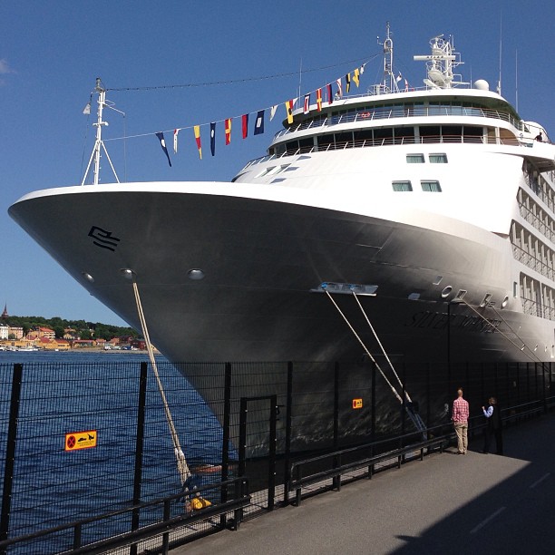 a cruise ship sits idle on a pier