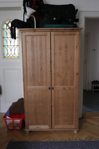 a small wooden cabinet that is open