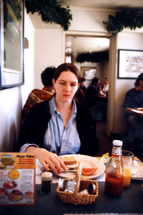 a person sitting at a table with food