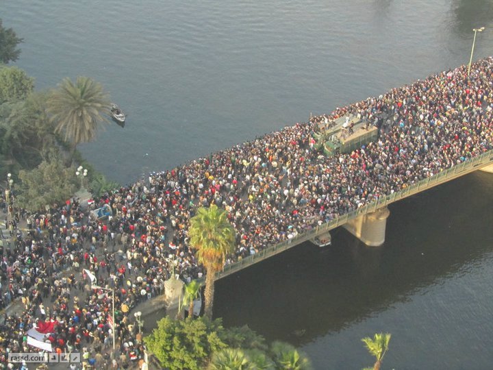 people are walking across the bridge to reach a boat