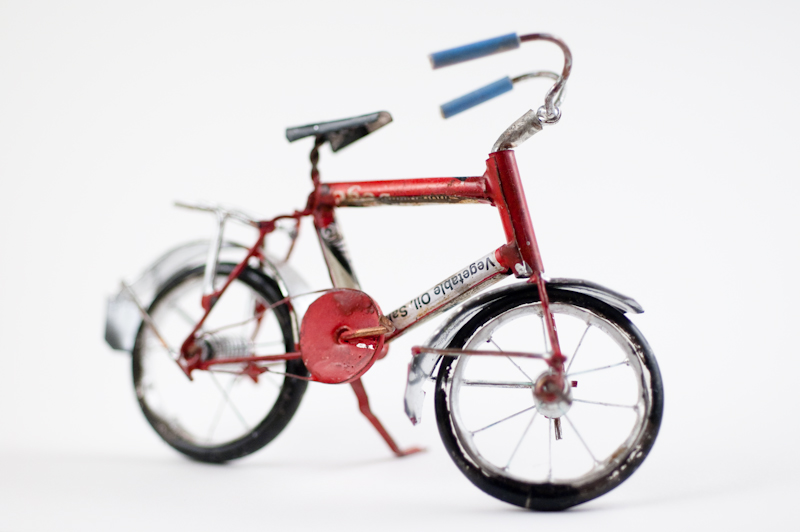 the toy bike is red, white and black