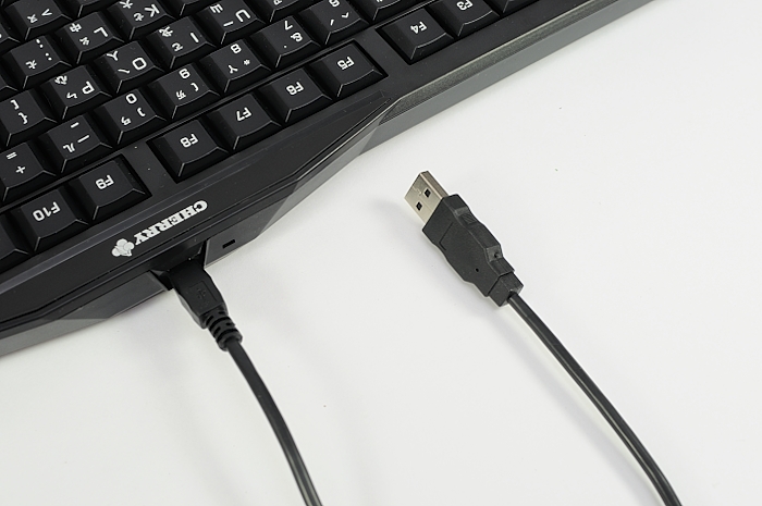 a keyboard with a black cord plugged into it