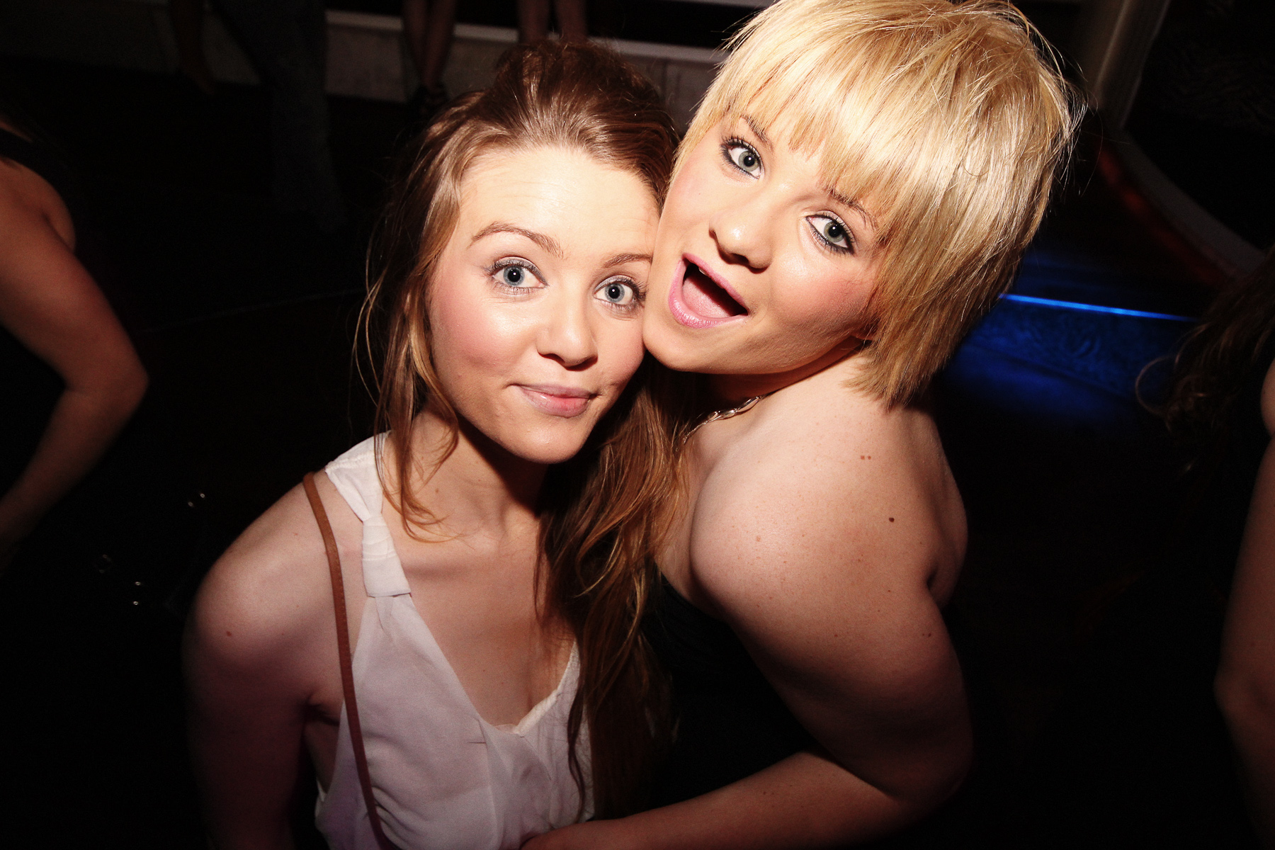 two women are smiling while posing for the camera