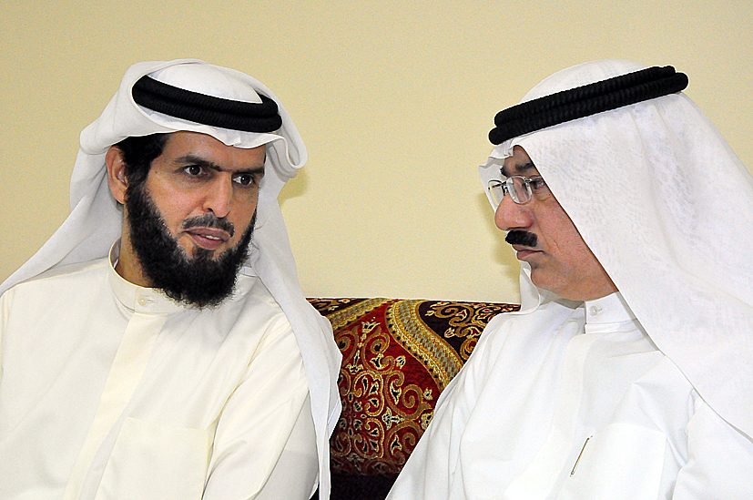 two men wearing white sitting down together