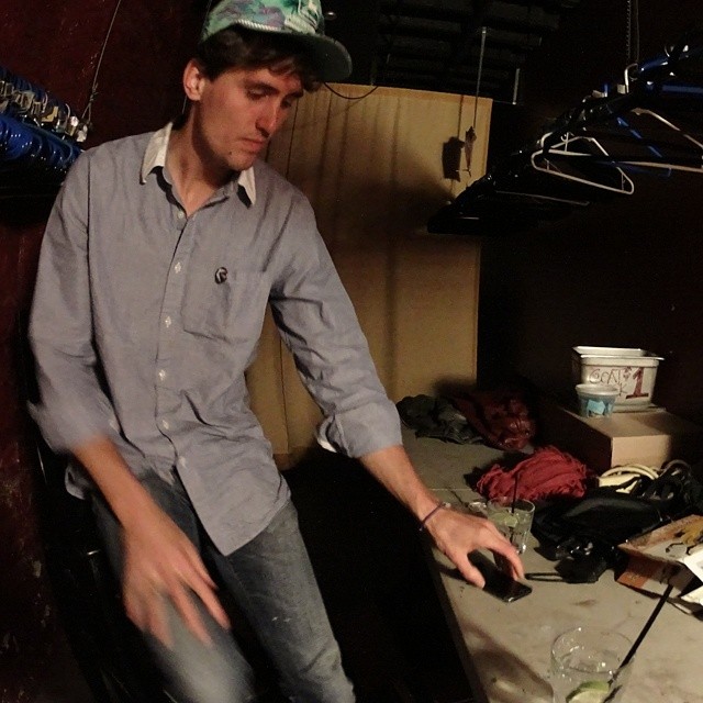 a man standing next to a table and holding a remote