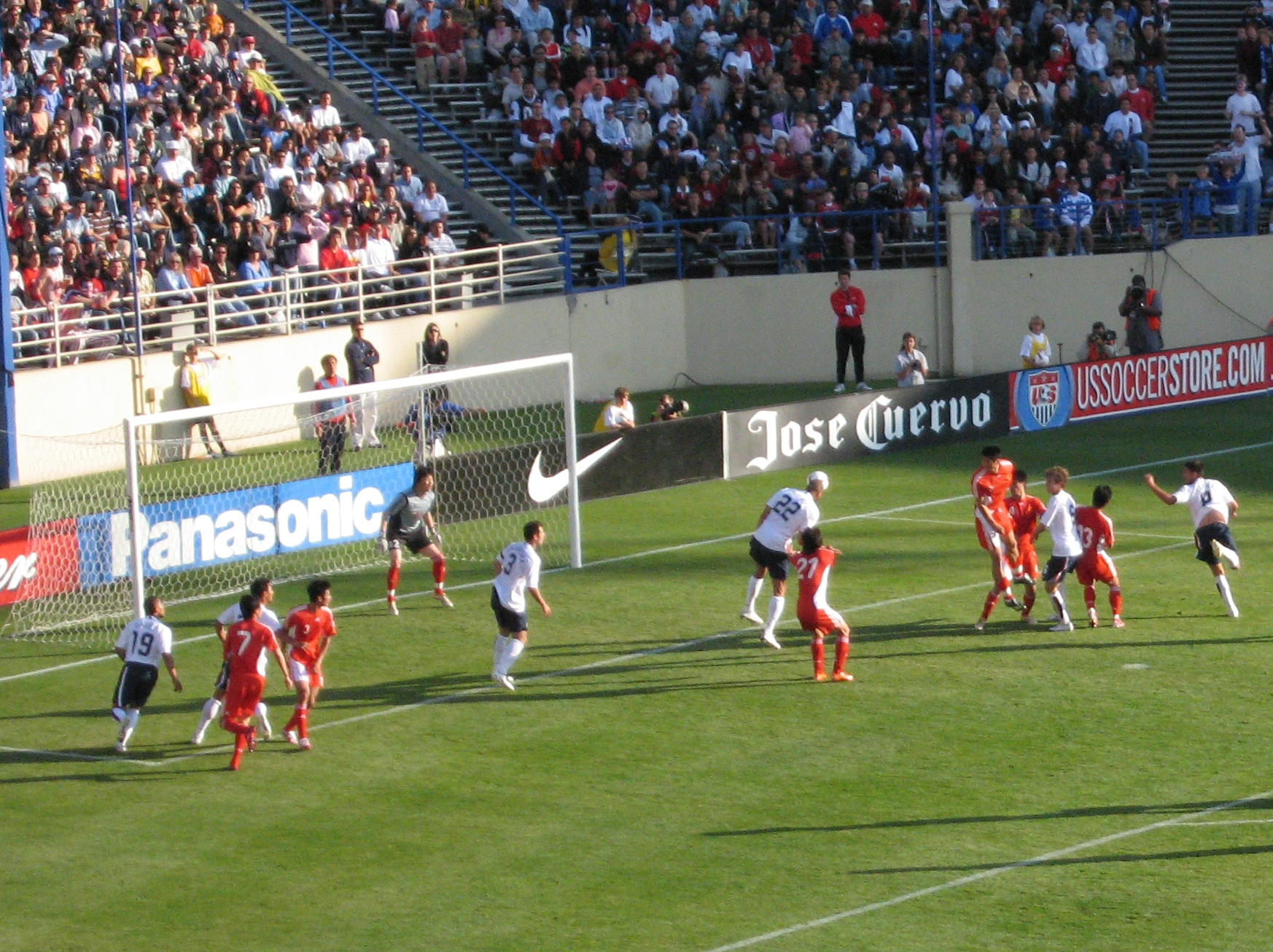 a group of people playing soccer in front of a crowd