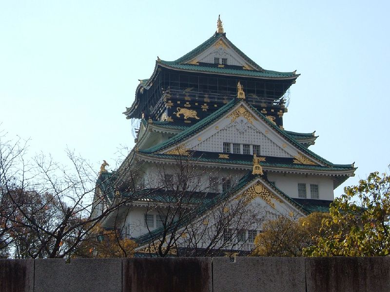 a large building sitting next to a fence