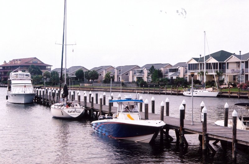 a pier is at the water with many boats