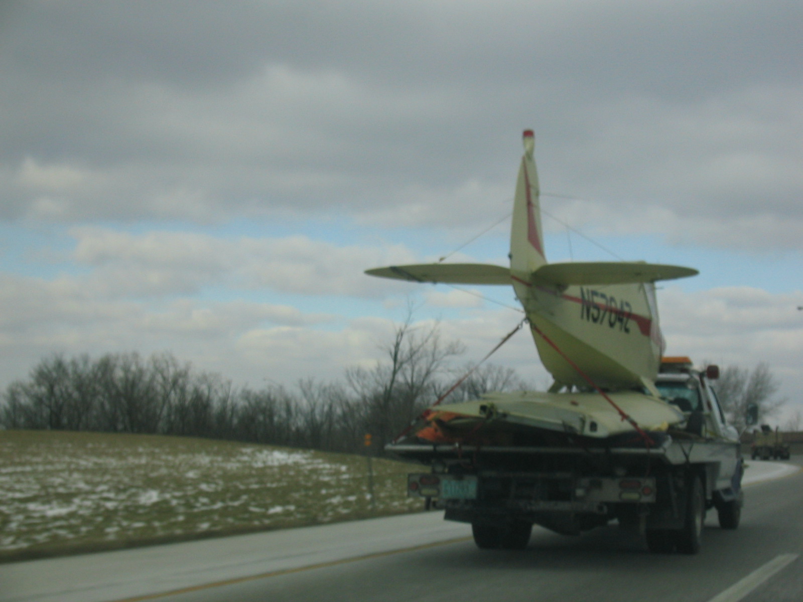 a truck carries a plane on the back of it