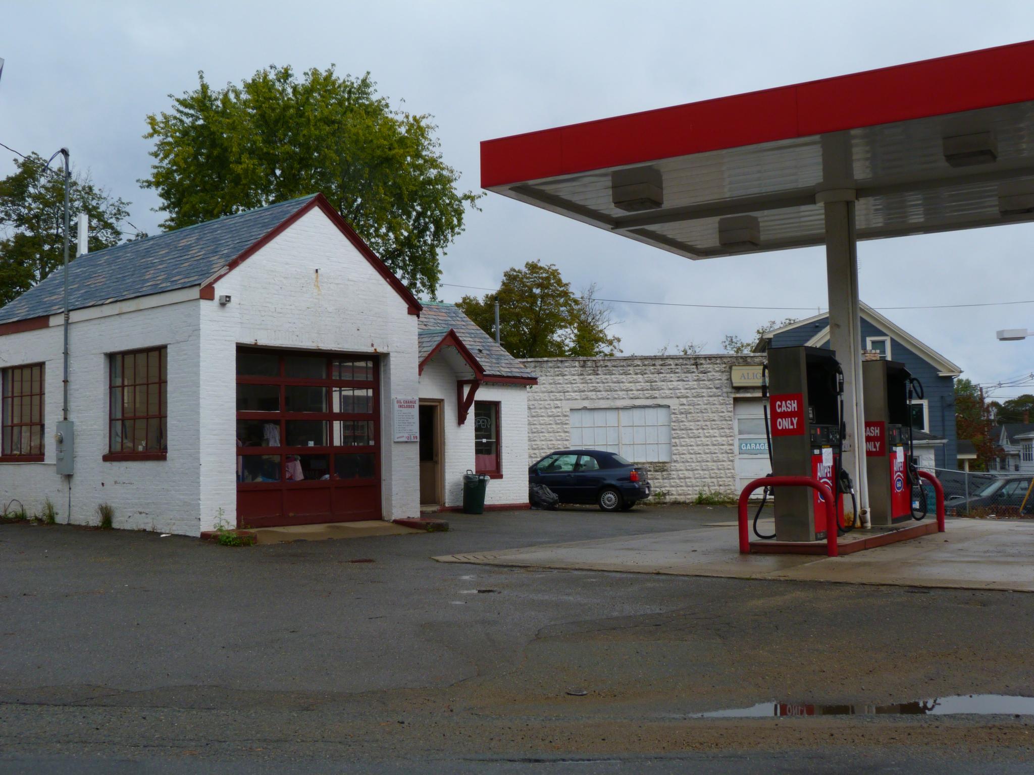 a white and red fire station with an older style car