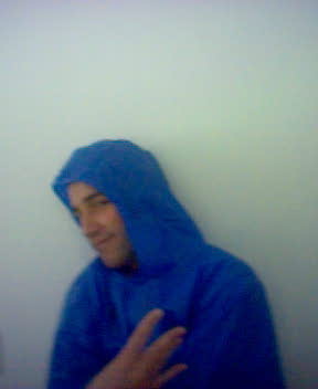 a man in a blue jacket and hooded hood posing for a picture