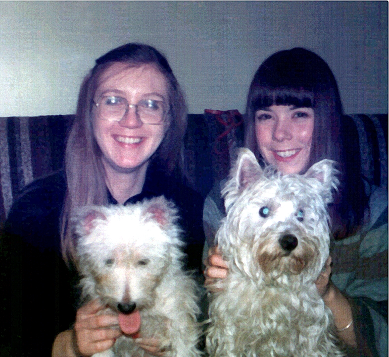 a girl poses for the camera with her two dogs