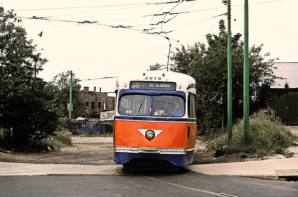 a very old bus with an orange front on the road