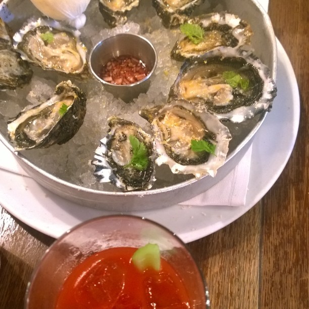 an oyster dish is set on a tray on a table