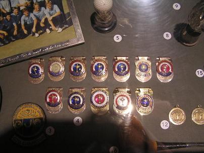 several badges are on a table next to a pograph