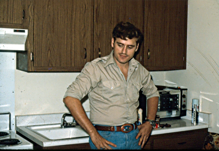 a man standing in front of a white sink
